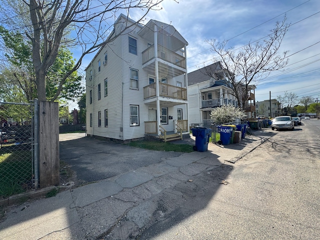 exterior space featuring fence and a balcony