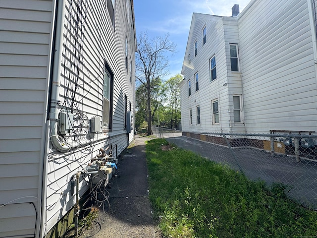 view of side of home with fence