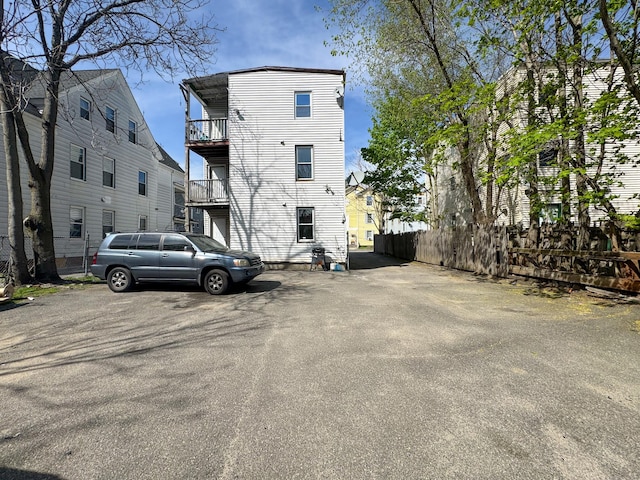 exterior space with fence and a balcony