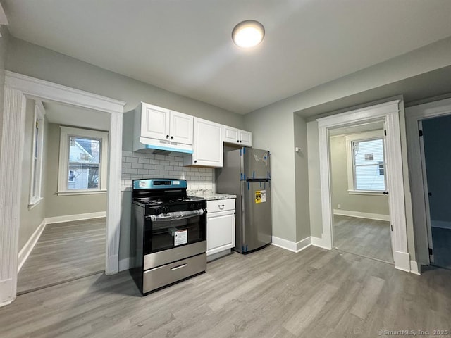 kitchen featuring under cabinet range hood, stainless steel appliances, white cabinetry, and light wood-type flooring