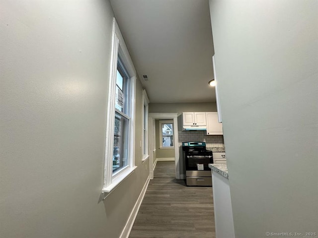 hall with baseboards and dark wood-style floors