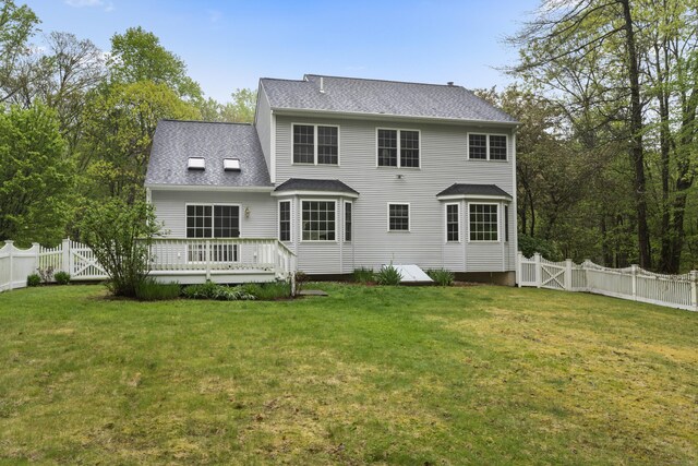 back of property featuring a fenced backyard, a deck, and a yard