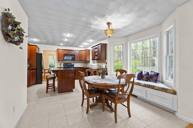 dining space with baseboards, light tile patterned floors, and recessed lighting