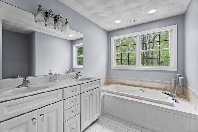 bathroom featuring a sink, a bath, visible vents, and tile patterned floors