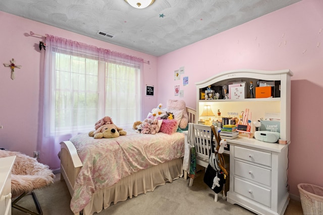 bedroom with visible vents and light colored carpet