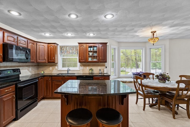 kitchen with black appliances, a sink, plenty of natural light, backsplash, and recessed lighting