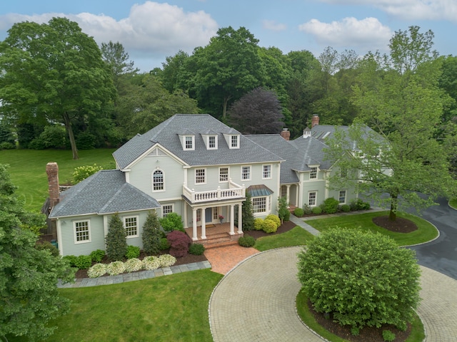 132 Belden Hill Rd, Wilton, CT 06897 - colonial home featuring a front yard, a chimney, and curved driveway