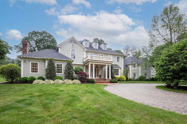 132 Belden Hill Rd, Wilton, CT 06897 - view of front of house featuring a front yard, a chimney, curved driveway, and a balcony