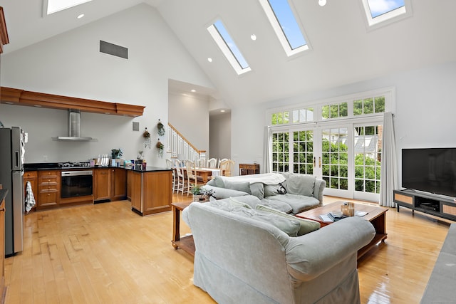 132 Belden Hill Rd, Wilton, CT 06897 - living room with high vaulted ceiling, a skylight, stairs, light wood-type flooring, and recessed lighting