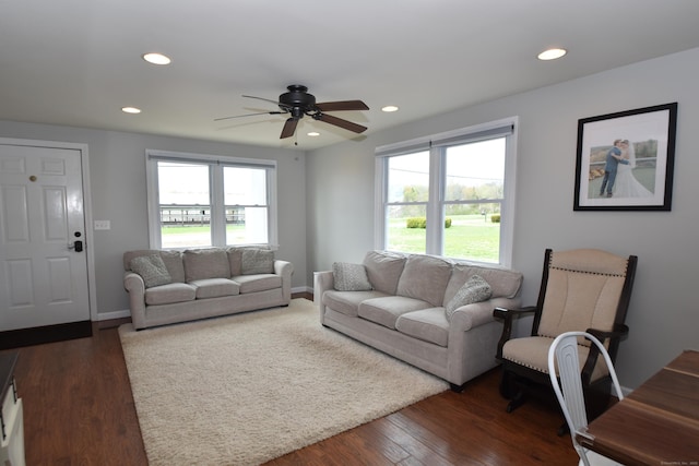 living area featuring dark wood-style flooring, recessed lighting, ceiling fan, and a healthy amount of sunlight