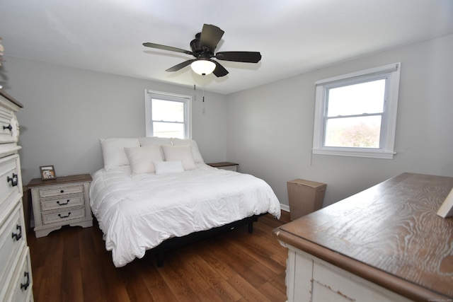 bedroom with a ceiling fan and dark wood-style floors