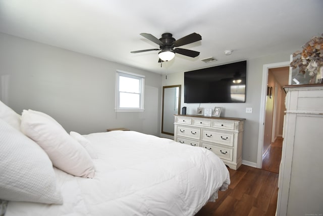 bedroom featuring baseboards, ceiling fan, dark wood-style floors, and visible vents