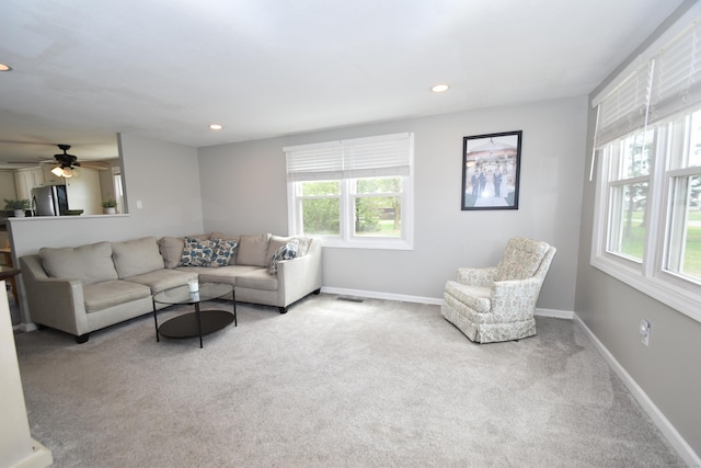 carpeted living area featuring recessed lighting, baseboards, and a ceiling fan