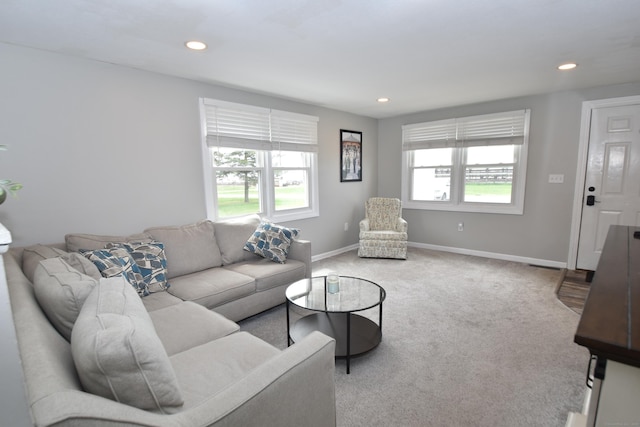 carpeted living area with baseboards and recessed lighting