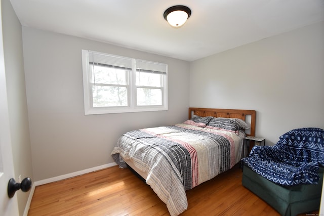 bedroom featuring baseboards and wood finished floors
