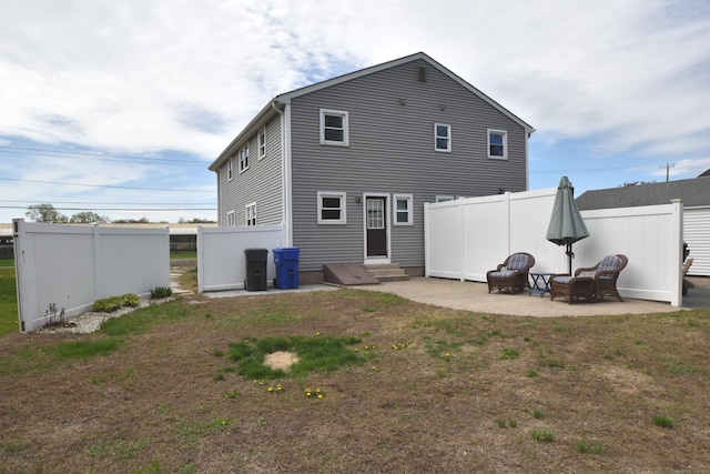 rear view of house featuring a yard, a patio, fence, and entry steps