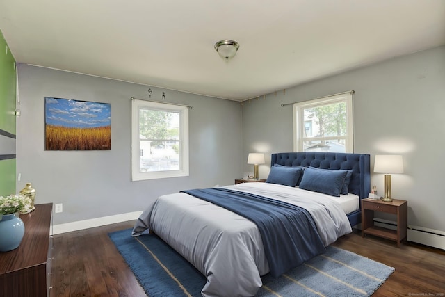 bedroom featuring wood finished floors, baseboards, and multiple windows