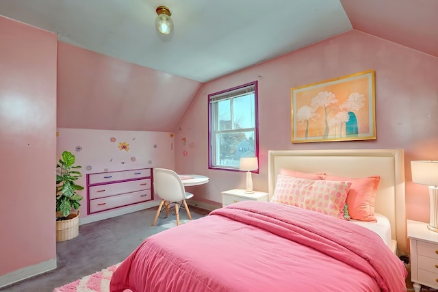bedroom with vaulted ceiling, baseboards, and carpet floors