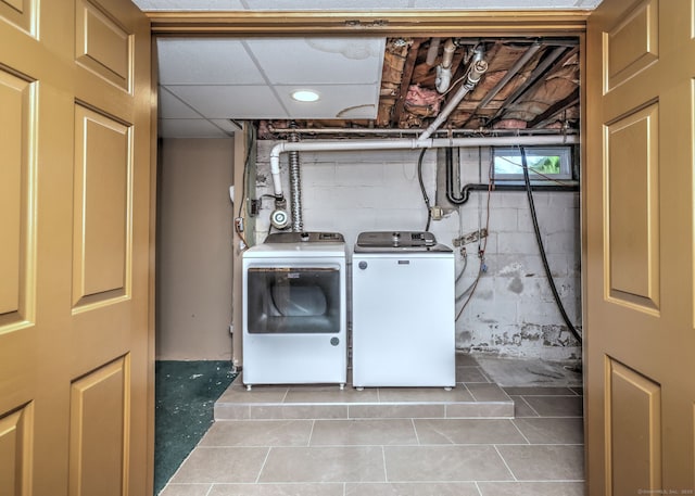 laundry area with washer and dryer, laundry area, and tile patterned flooring