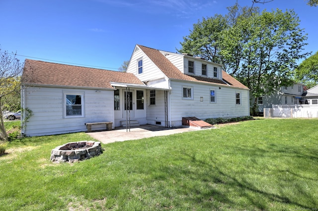 back of property with an outdoor fire pit, a patio, and a lawn