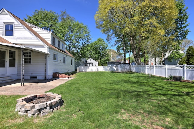 view of yard with an outdoor fire pit, a patio area, and fence