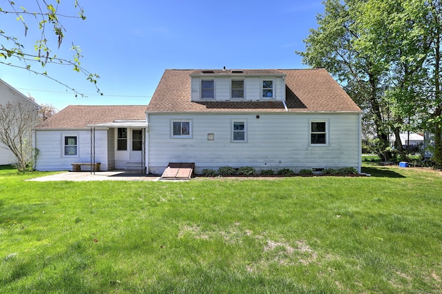 back of property featuring a yard and a patio