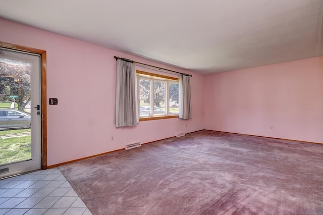 145 Russell Rd, Stratford, CT 06614 - spare room featuring healthy amount of natural light, light colored carpet, light tile patterned floors, and baseboards