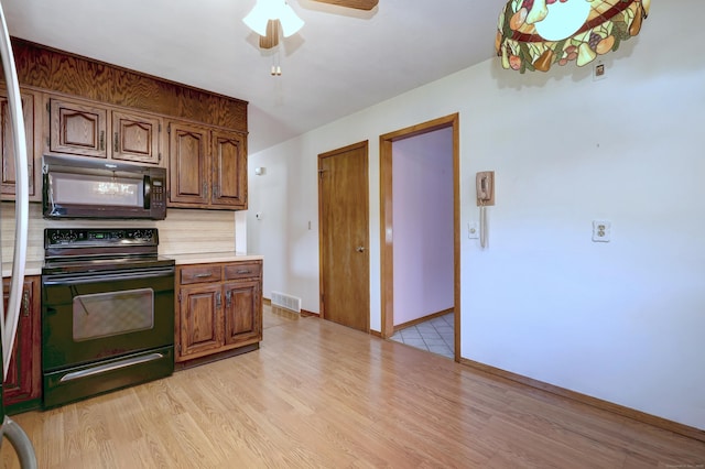 145 Russell Rd, Stratford, CT 06614 - kitchen featuring black appliances, light countertops, a ceiling fan, light wood finished floors, and baseboards