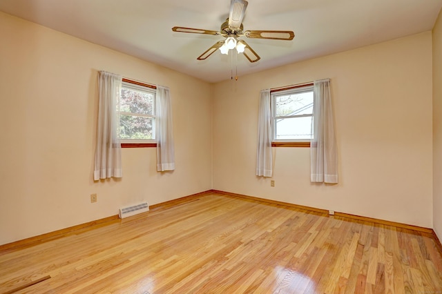 145 Russell Rd, Stratford, CT 06614 - empty room featuring healthy amount of natural light, wood finished floors, baseboards, and a ceiling fan