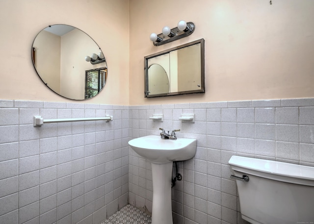 145 Russell Rd, Stratford, CT 06614 - bathroom featuring wainscoting, tile walls, and toilet