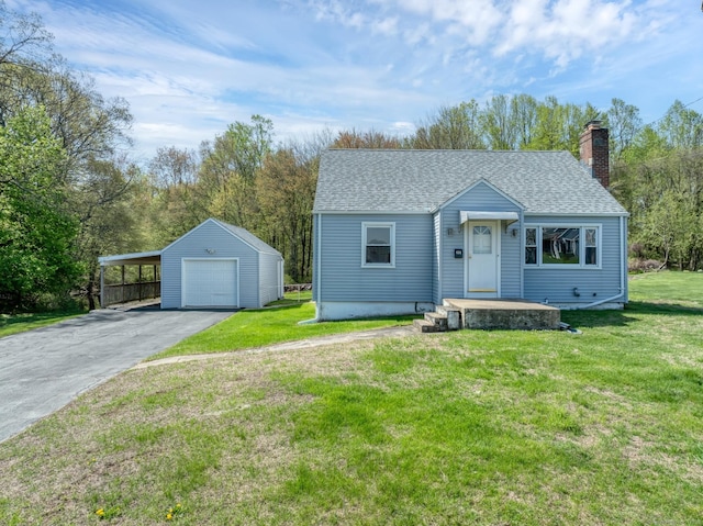bungalow-style home featuring a shingled roof, aphalt driveway, a front yard, an outbuilding, and a chimney