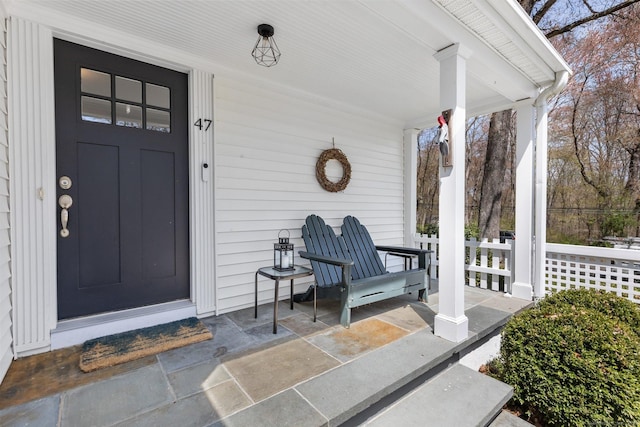 view of exterior entry with covered porch