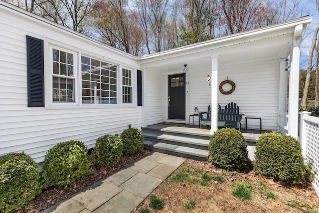 view of exterior entry with a porch