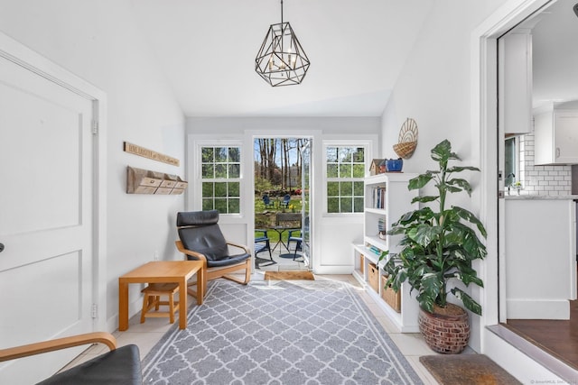 living area with lofted ceiling and light tile patterned flooring