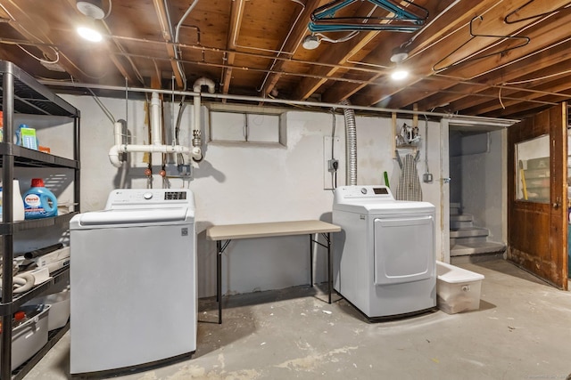 washroom featuring laundry area and separate washer and dryer