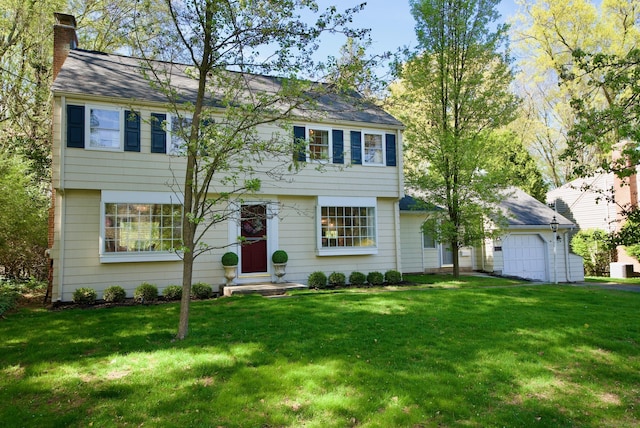colonial house with a chimney and a front yard