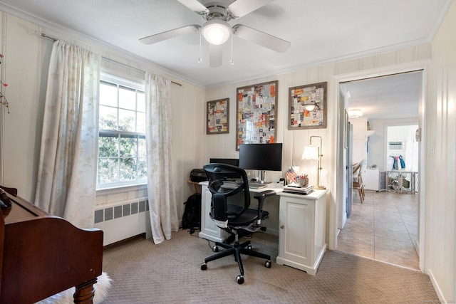 office space featuring radiator heating unit, ornamental molding, light carpet, and a ceiling fan