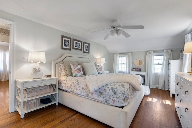 bedroom featuring a ceiling fan, vaulted ceiling, and dark wood-style flooring
