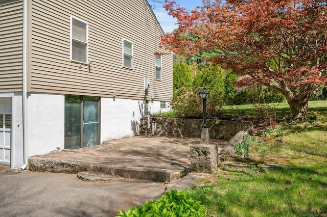 view of property exterior featuring a patio area