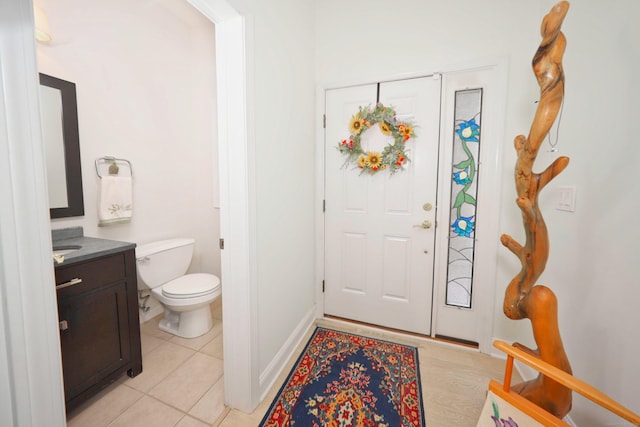 interior space with light tile patterned flooring and baseboards