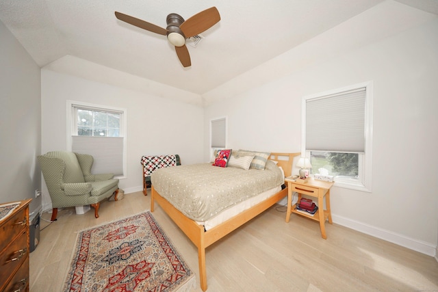 bedroom featuring baseboards, a ceiling fan, and light wood finished floors