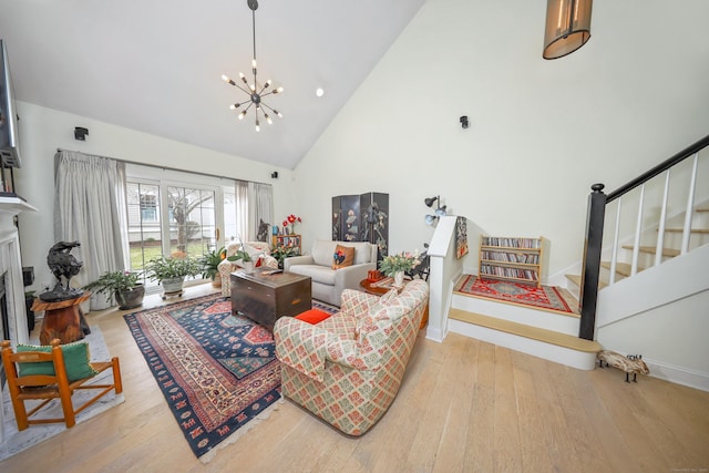 living room with a notable chandelier, wood-type flooring, high vaulted ceiling, stairs, and baseboards