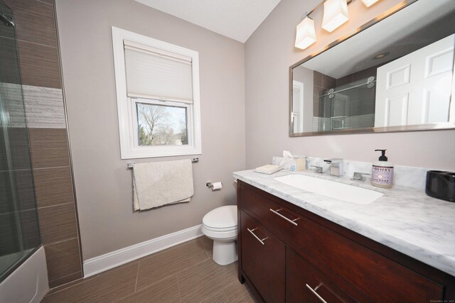 bathroom featuring baseboards, vanity, and toilet