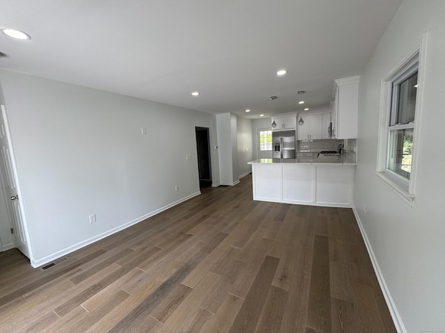 59 Fairfax St, Waterbury, CT 06704 - kitchen with stainless steel refrigerator with ice dispenser, recessed lighting, wood finished floors, white cabinets, and light countertops