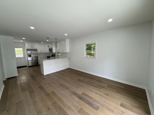 59 Fairfax St, Waterbury, CT 06704 - kitchen with stainless steel appliances, a peninsula, dark wood-type flooring, light countertops, and recessed lighting