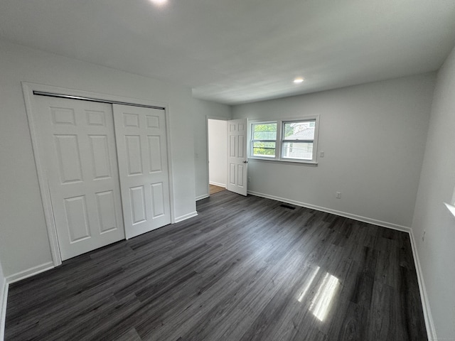 59 Fairfax St, Waterbury, CT 06704 - unfurnished bedroom with baseboards, dark wood finished floors, a closet, and recessed lighting