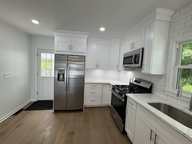 59 Fairfax St, Waterbury, CT 06704 - kitchen featuring appliances with stainless steel finishes, a sink, light stone counters, dark wood finished floors, and white cabinetry