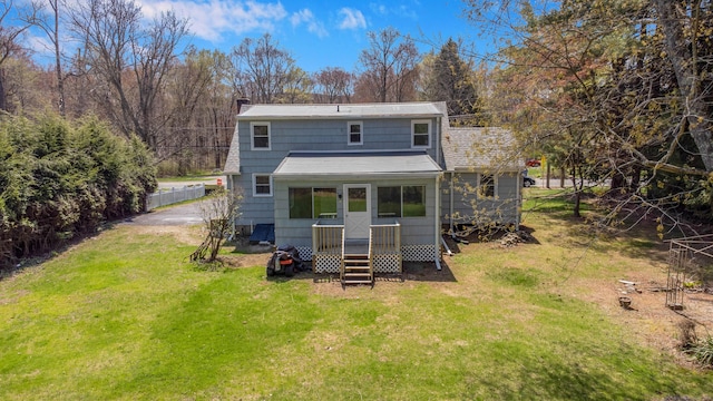back of property featuring a lawn and a chimney