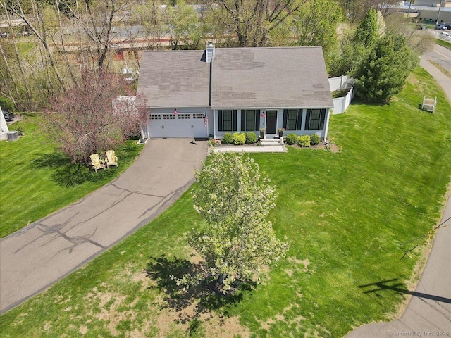 view of front of home featuring a garage, a front yard, and aphalt driveway