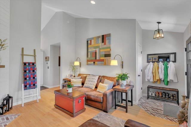 living room featuring baseboards, recessed lighting, wood finished floors, and high vaulted ceiling